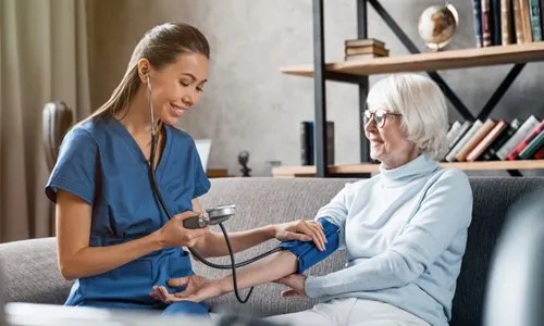 Caregiver assisting a senior with health needs at home