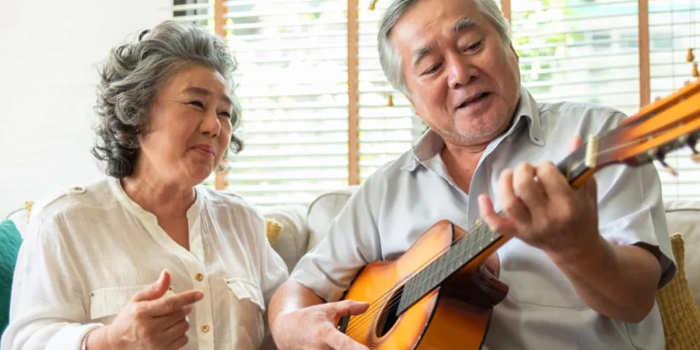 Older couple enjoying music together at home