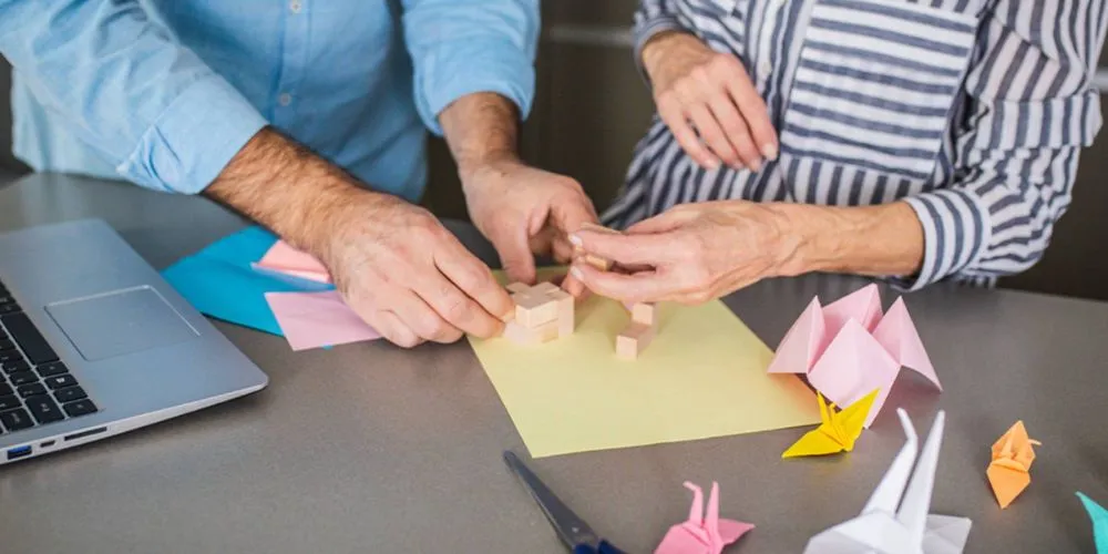 Caregiver gently guiding a senior’s hands