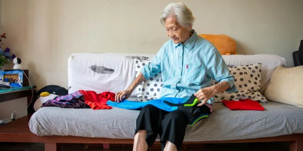 Senior sorting laundry at home
